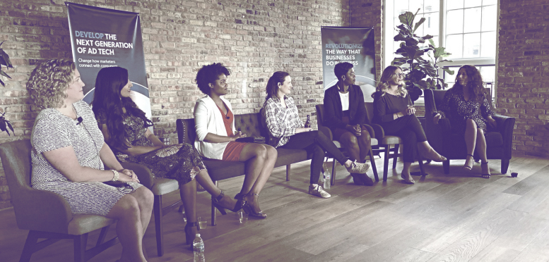 Heather Corallo sitting on a panel with a few women