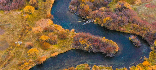 A photo of a winding river with Heather Corallo in a circle talking to a women